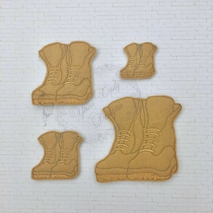 May include: Four pairs of brown leather boots with laces. The boots are in different sizes.