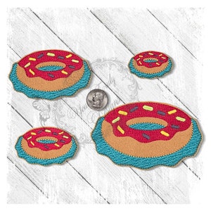 May include: Three embroidered donut patches in different sizes. The donuts are brown with red frosting and yellow and purple sprinkles. The donuts have a blue icing border.