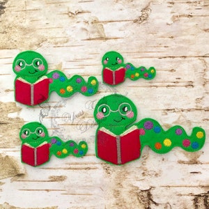 May include: Three green felt bookworm appliques with red books and colorful dots. The bookworms have googly eyes and glasses.