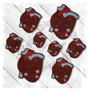May include: Set of seven felt heart-shaped ornaments with embroidered faces. The hearts are various sizes and feature a red, brown, and blue color scheme.