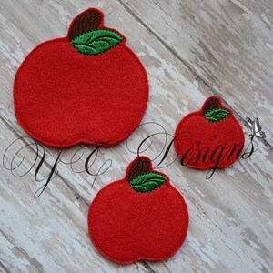 May include: Three felt apple shapes in different sizes. The apples are red with green leaves and brown stems.