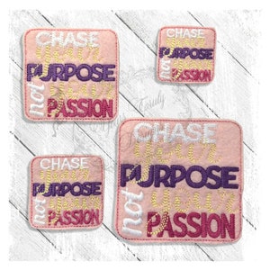May include: Three pink felt squares with the text "Chase Your Purpose Not Your Passion" in white, gold, and purple lettering. The squares are different sizes.