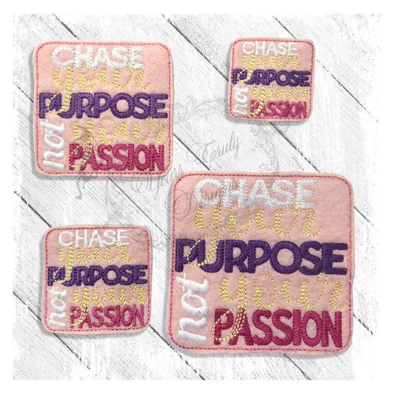 May include: Three pink felt squares with the text "Chase Your Purpose Not Your Passion" in white, gold, and purple lettering. The squares are different sizes.
