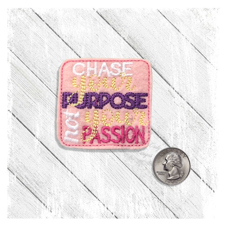 May include: Pink felt square patch with embroidered text that reads "Chase your purpose not your passion".