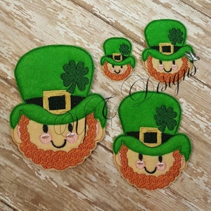 May include: Three felt appliques of a leprechaun's face with a green hat, a shamrock, and a gold buckle. The appliques are in different sizes.