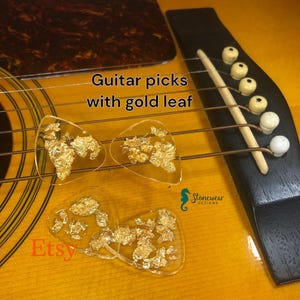 Guitar picks with gold flakes in resin