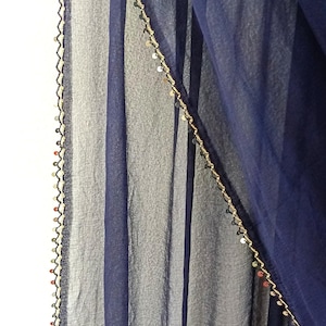 May include: A white ceramic mug with a black handle and the text "But First, Coffee" in a black, bold font. The mug is sitting on a wooden surface. The mug is 4 inches tall.