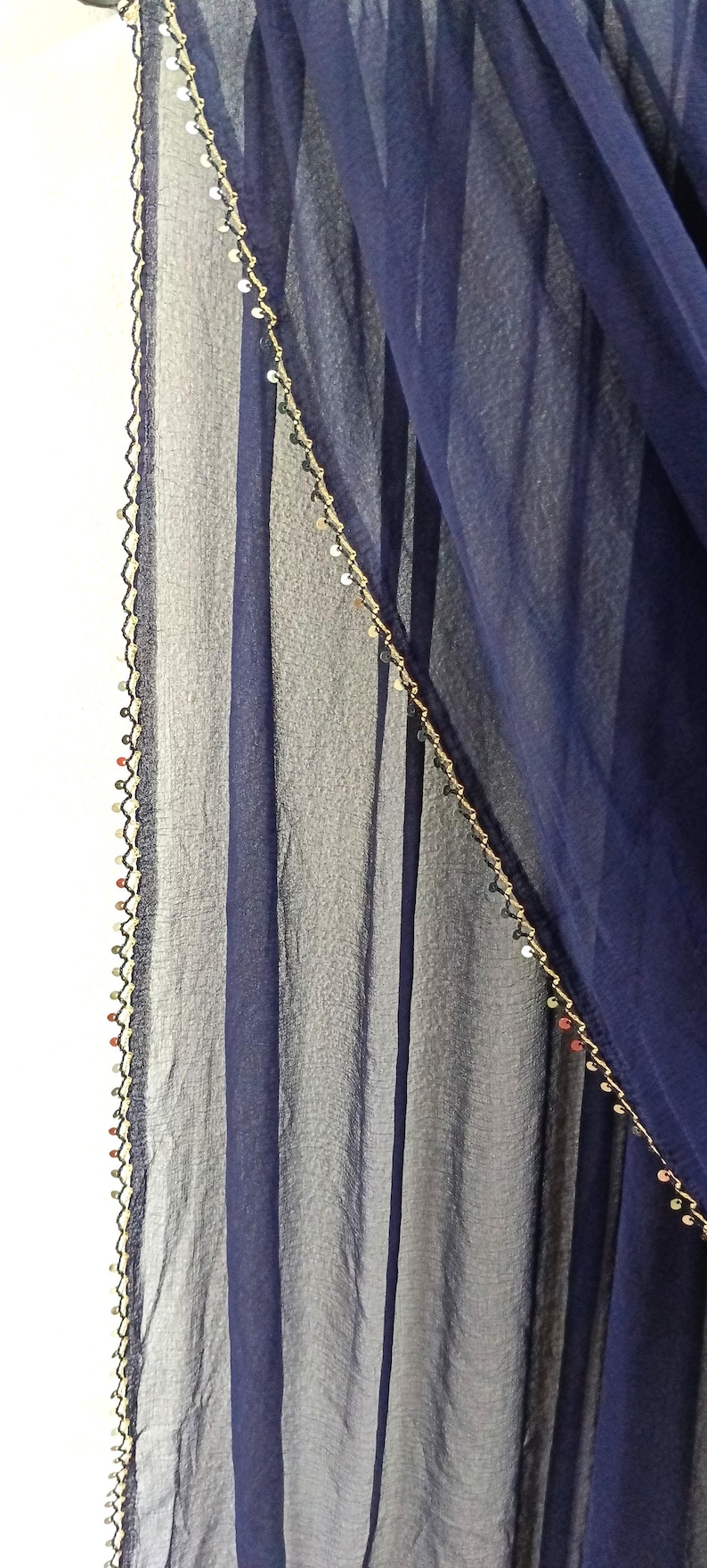 May include: A white ceramic mug with a black handle and the text "But First, Coffee" in a black, bold font. The mug is sitting on a wooden surface. The mug is 4 inches tall.