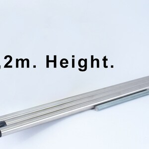 May include: Three silver metal poles with black tips, and a silver metal screw, with the text "1,2m. Height." above them.