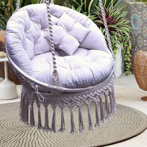 Comfortable hanging hammock chair, macrame, butterfly pattern on the back, chic, large pillows, roomy, cozy, for the whole family.