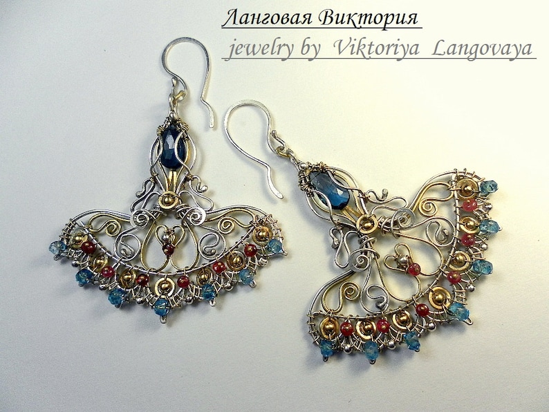 May include: Silver and gold wire earrings with blue and red gemstones. The earrings are shaped like a fan and have a delicate, intricate design. The text "jewelry by Viktoriya Langovaya" is visible in the image.