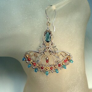May include: Silver and gold filigree earrings with a teal gemstone and red and blue beads.