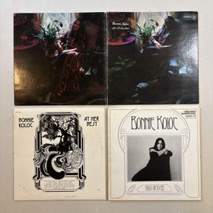 May include: Four vintage vinyl records by Bonnie Koloc. The album covers feature images of the artist, along with text including "Bonnie Koloc", "At Her Best", and "Hold On To Me". The album "Bonnie Koloc after all this time" is also visible.