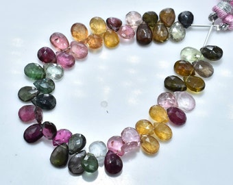 May include: A strand of faceted gemstone beads in various colors, including green, pink, brown, and clear. The beads are teardrop shaped and strung on a thin wire.