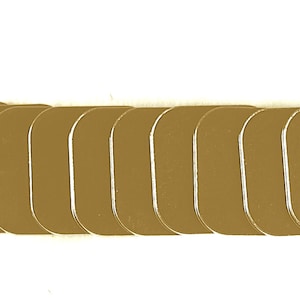 May include: A set of 12 gold-colored, square-shaped coasters. The coasters are made of a smooth, hard material and have a slightly rounded edge.