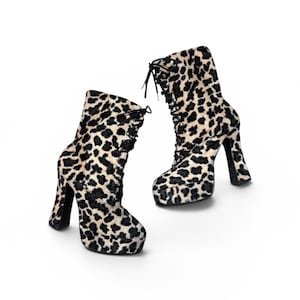 May include: A pair of high-heeled ankle boots with a leopard print pattern. The boots have a lace-up design and a platform sole. The heels are approximately 4 inches high. The boots are set against a white background.