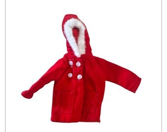 May include: A vibrant red hooded coat with a white faux fur trim around the hood. The coat features three white buttons and two pockets. The sleeves are extended. This coat is suitable for a child.