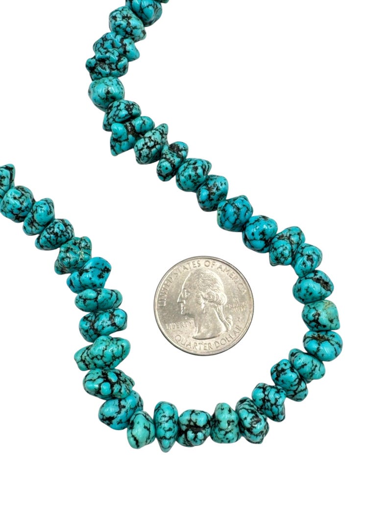 Puede incluir: Un collar de cuentas de turquesa irregulares y pulidas con tonos azul verdosos vibrantes y vetas oscuras. Las cuentas est&aacute;n dispuestas en forma curva junto a una moneda de 25 centavos de d&oacute;lar estadounidense de 2,43 cm de di&aacute;metro.