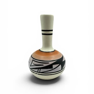 May include: A small, handcrafted ceramic vase with a rounded body and a long, slender neck. The vase features a cream-colored neck with black stripes, an orange band, and a geometric black and gray design on the body. The vase is likely used for decorative purposes.