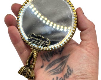 Espejo de mano Stylebuilt de cristal chapado en oro de 24 quilates, estilo Hollywood Regency, de los años 60. Espejo de tocador de mano Stylebuilt.