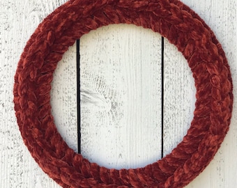 May include: A brown braided velvet wreath, perfect for a fall or winter decor theme.