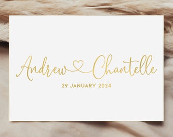 May include: A white card with gold lettering announcing the wedding of Andrew and Chantelle on 29 January 2024.