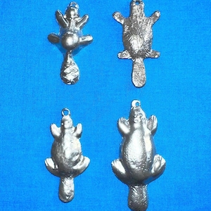 Puede incluir: Cuatro abalorios de ornitorrinco de color plateado, cada uno con una pose diferente. Los abalorios miden aproximadamente 5 cm de alto y tienen un bucle en la parte superior para colgar.