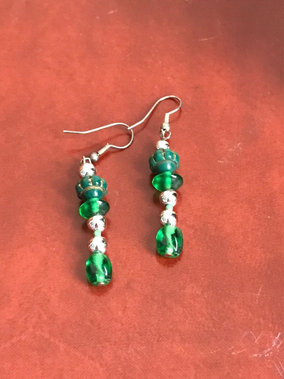 Silver dangle earring with green beads