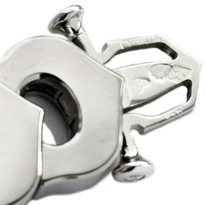 May include: Close-up of a silver metal bracelet clasp with a detailed design. The clasp has two screws and a small engraved design that includes the words '925 Italy'.