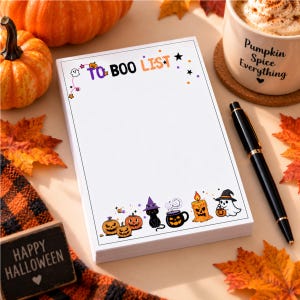 May include: A rectangular notepad with a white background featuring the text TO BOO LIST at the top. The border includes colorful Halloween illustrations of pumpkins, a black cat in a witch hat, a steaming cauldron, a candle, and a ghost.
