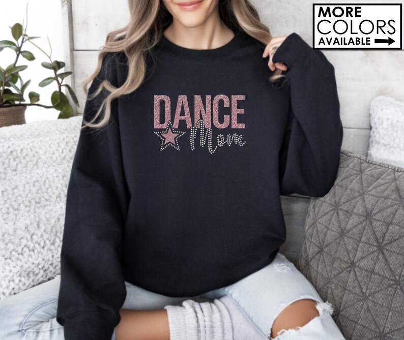 May include: Black sweatshirt with a pink glitter design that says "Dance Mom" with a pink glitter star.