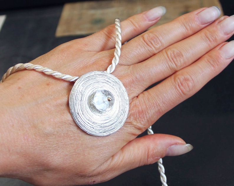 rock crystal pendant with spiral pattern of 925silver and 750gold
