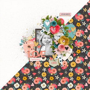 May include: A scrapbook page with a black and white photo of a baby girl surrounded by colorful flowers, hearts, and ribbons. The page has the words "LOVE" and "LIFE IS SWEET" on it. The background is a dark gray with a floral pattern.
