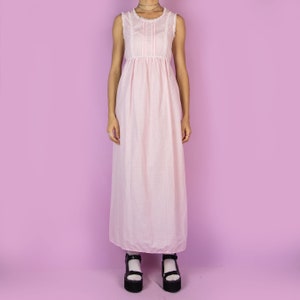 The Vintage 90s Pink Slip Maxi Dress is a light pastel pink polka dot midi dress featuring white lace details and ties at the back. Romantic 1990s night dress.