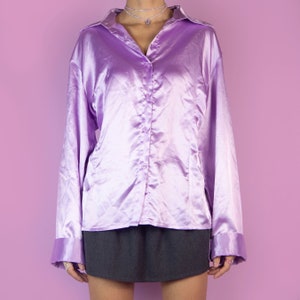 The Y2K Lilac Satin Blouse is a vintage bright pinkish-purple shirt with a collar and buttons. Elegant preppy 2000s office work blouse.