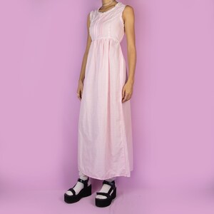 The Vintage 90s Pink Slip Maxi Dress is a light pastel pink polka dot midi dress featuring white lace details and ties at the back. Romantic 1990s night dress.