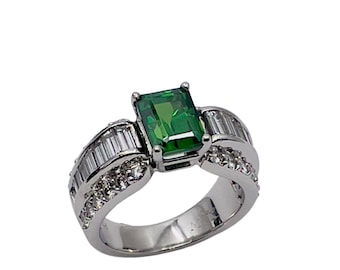 Green tourmaline about 1.75 cts. set in Platinum ring with baguettes along the shank.