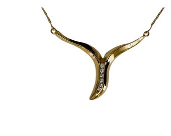 14k yellow gold necklace with .17 carats of green Tsavorite's