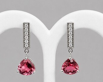 2.59 carats Pink Tourmaline dangle earrings in 14k white gold.  Accented with .14 carats of diamonds.