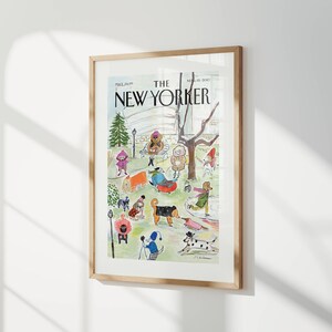 May include: Framed print of a New Yorker magazine cover. The illustration depicts a park scene with people and dogs enjoying winter activities. The text "THE NEW YORKER" is prominently displayed at the top.