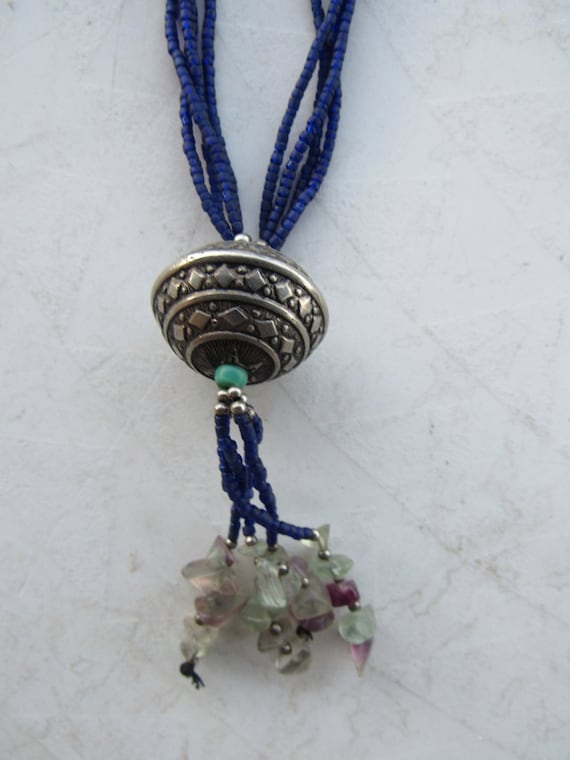 Yuya black choker with an African bronze mask pendant.