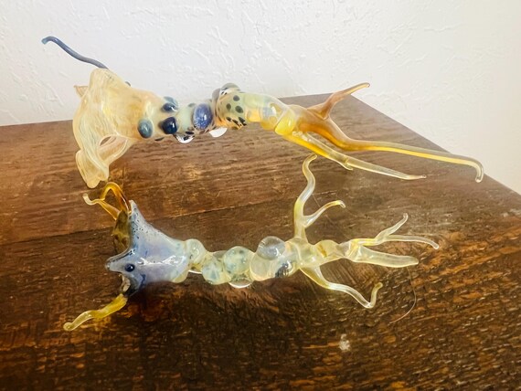 A set of two Chihuly-inspired hand-blown glass sea creatures that bring an oceanic, sculptural energy to any shelf or windowsill.