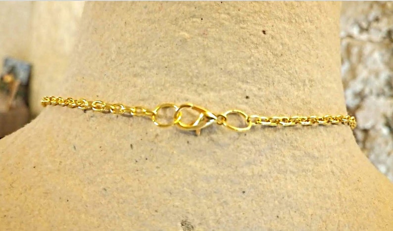 Gold chain rhinestone pendant necklace very glamorous and a gold rhinestone metal charm with a gold rhinestone-plated charm