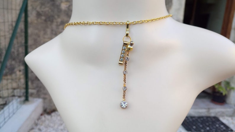 Gold chain rhinestone pendant necklace very glamorous and a gold rhinestone metal charm with a gold rhinestone-plated charm