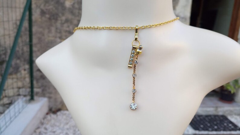 Gold chain rhinestone pendant necklace very glamorous and a gold rhinestone metal charm with a gold rhinestone-plated charm