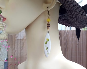 Perfect gift, ceramic earrings with floral patterns on a white background, coconut wood, yellow and beige wood, bronze hook