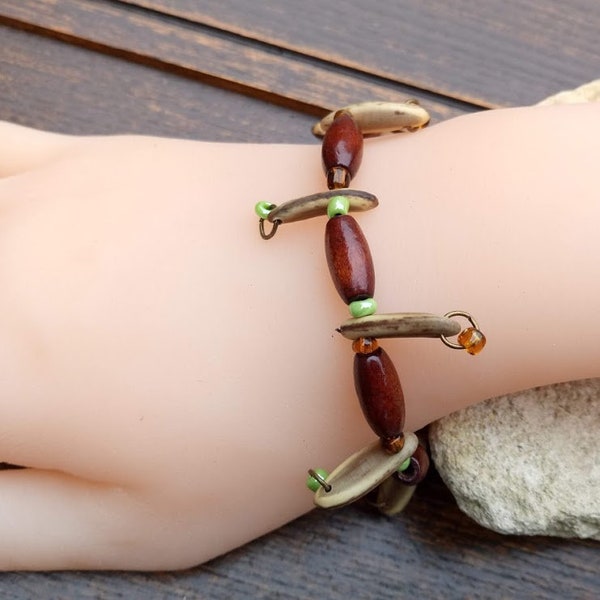 Perfect gift, stretch bracelet, brown oblong wooden beads, green and bronze seed beads, and acacia seeds