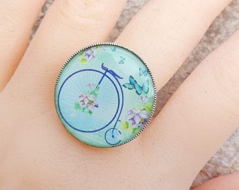 Perfect gift, large old bicycle image ring, large bi velocipede, light blue background, adjustable triple silver ring support