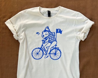 Feminist / Feminism T-Shirt Depicting Quote "A woman needs a man like a fish needs a bicycle."