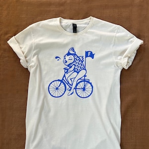 Feminist / Feminism T-Shirt Depicting Quote &quot;A woman needs a man like a fish needs a bicycle.&quot;